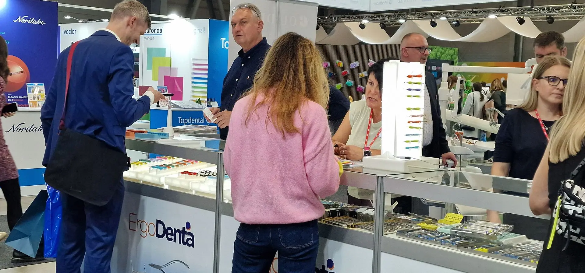 Dentists exploring ErgoDenta’s Danish-designed instruments at Janouch-Dental’s booth